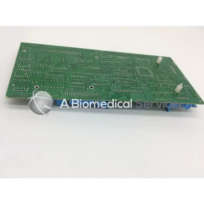 Green rectangular circuit board with intricate silver traces and blue connectors for advanced input devices side b