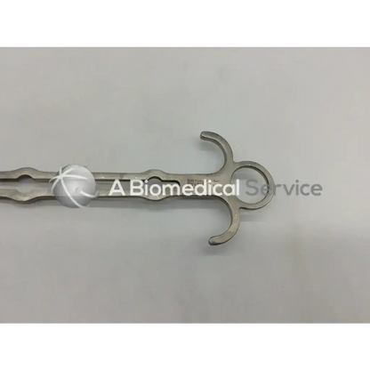 Stainless steel aesculap bv609r retractor with curved handle and two opposing prongs for surgical use