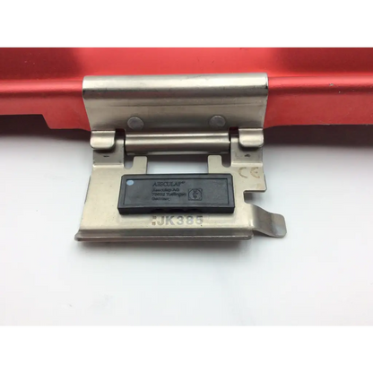 Stainless steel hinge with black plastic aisqual label on jk385 lid of aesculap jn341 half-size perforated retention plate