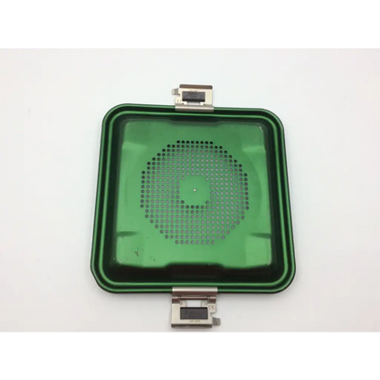 Green rectangular plastic aesculap jn341 half-size perforated retention plate container with circular perforations and metallic clasp hinges
