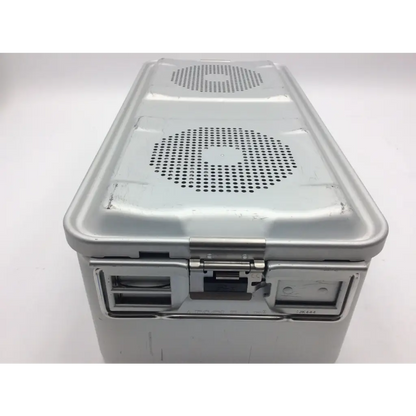 Silver metallic aesculap sterile container case with perforated lid vents and sturdy latch mechanism for surgical use