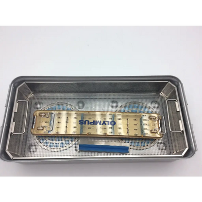 Gold-colored aesculap sterilization container tray with mesh interior and side handles featuring olympus wa05990a design