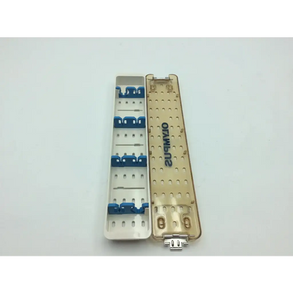 Gold-colored aesculap sterilization container with blue clips and silver connector featuring olympus wa05990a branding