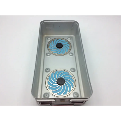 Silver rectangular aesculap sterilization tray jf224r with two blue spiral-patterned circular inserts and black centers