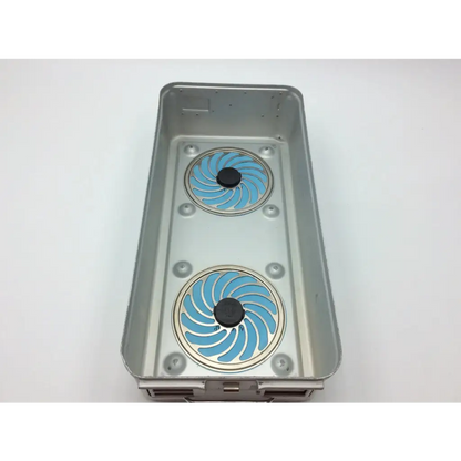 Silver metal aesculap sterilization tray jf224r with two blue spiral-patterned circular inserts and black centers