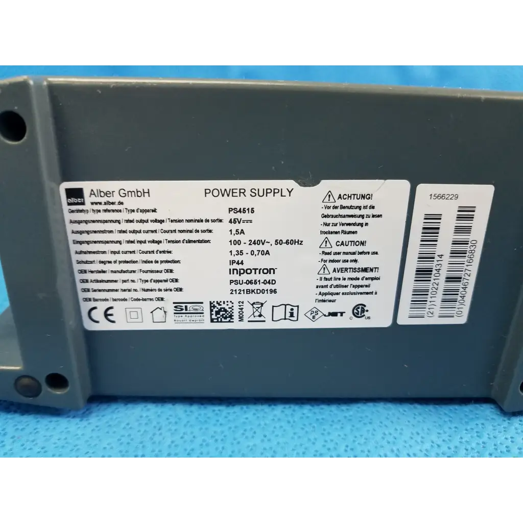 Gray plastic alber e-fix viamobil ps4515 power supply with white label showing technical specs and safety warnings