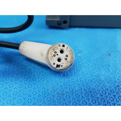 White plastic connector with metal pins and black cable showing wear on the back of alber e-fix viamobil power supply