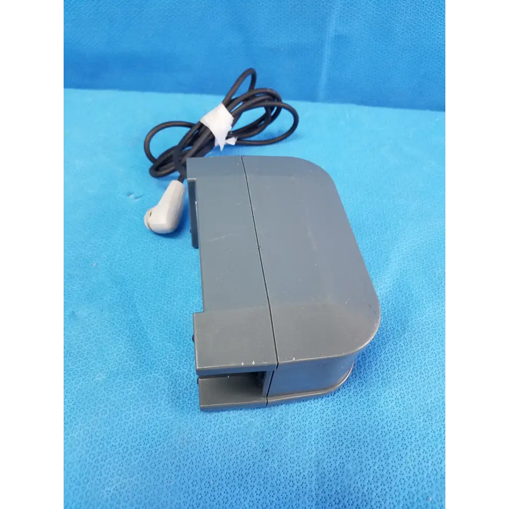 Gray plastic foot pedal with black coiled cable and white connector for alber e-fix viamobil power supply charger