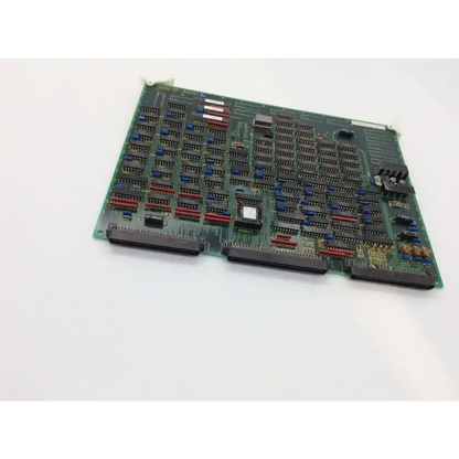 Green printed circuit board with black and blue integrated circuits red connectors and central component aloka ep-3320h