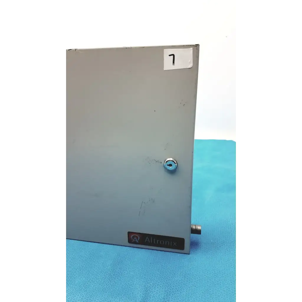 Gray metallic altronix al400ulx power supply charger enclosure with keyed lock and small protruding connector