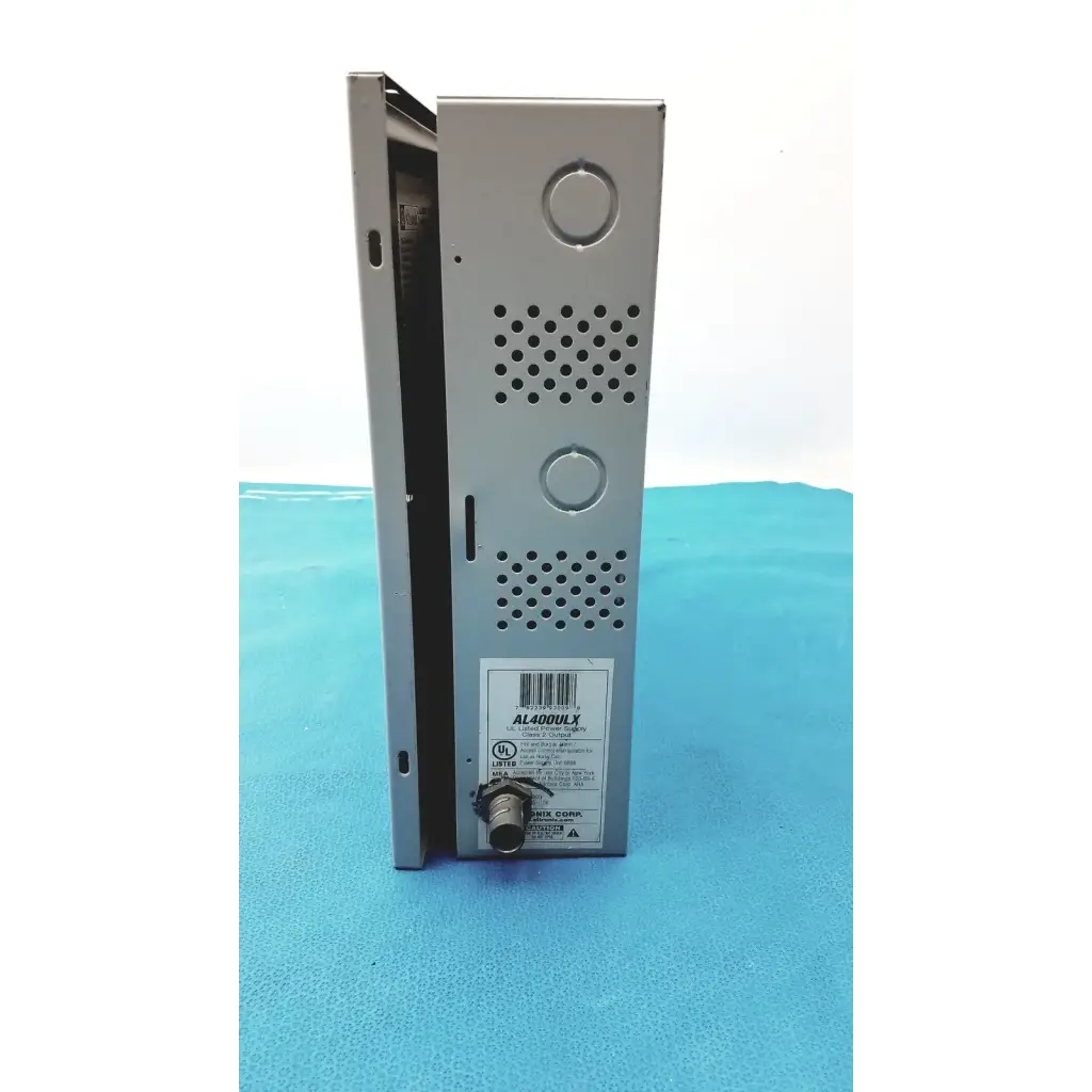 Silver metallic altronix al400ulx power supply with perforated ventilation panels and circular connector port visible