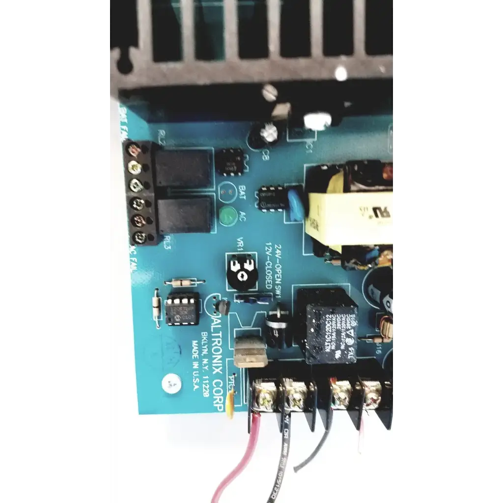 Blue altronix al400ulx power supply pcb with black components and labeled connectors for 12vdc or 24vdc output