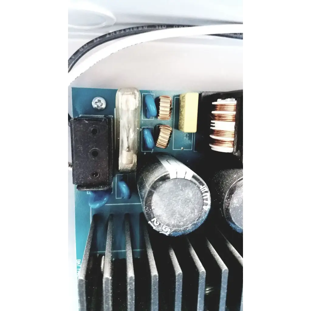 Black cylindrical capacitor with silver metallic top and white labeling on altronix al400ulx power supply charger side