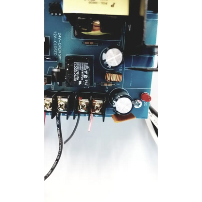 Blue circuit board of altronix al400ulx power supply with black silver components capacitors resistors and red button