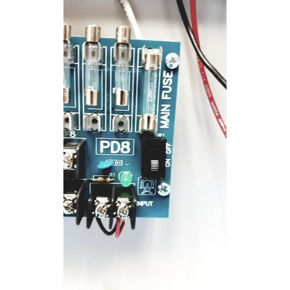 Blue circuit board of altronix smp5ctx high current power supply charger with eight glass fuses and on off switch