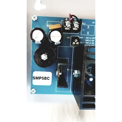 Blue printed circuit board with black capacitors and screws of altronix smp5ctx high current power supply charger
