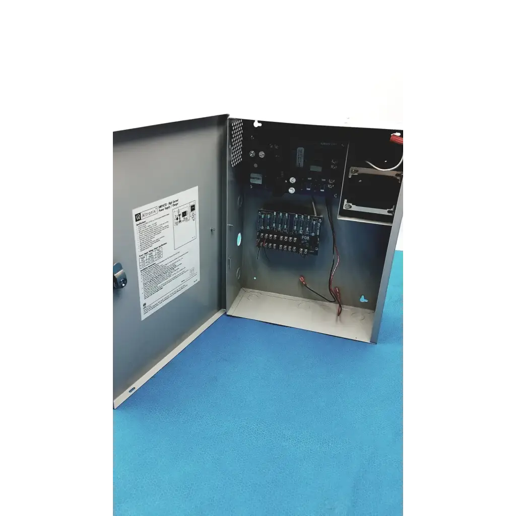 Gray metal electrical control panel of altronix smp5ctx high current power supply charger with visible wiring