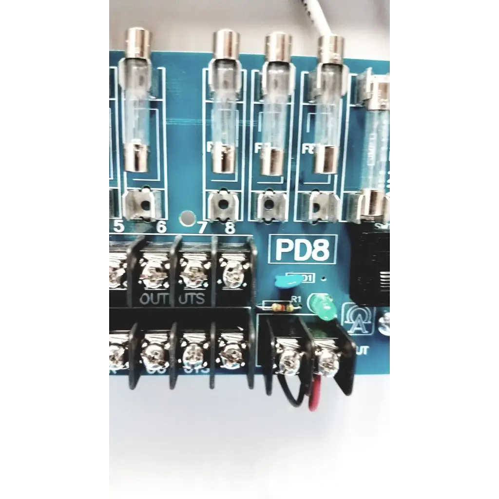 Blue circuit board with transparent glass fuses and black terminal blocks in altronix smp5ctx high current power supply
