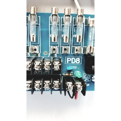 Blue circuit board with transparent glass fuses and black terminal blocks in altronix smp5ctx high current power supply
