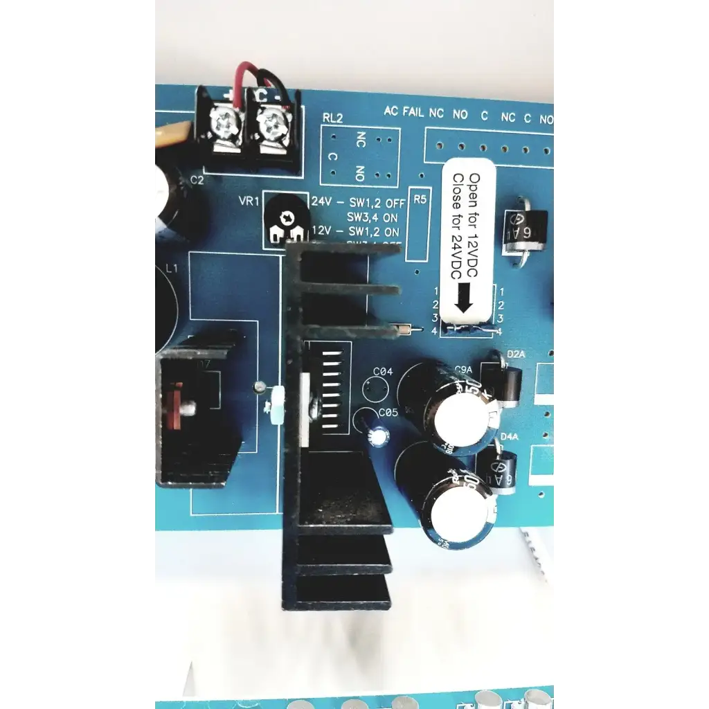Blue circuit board with black components and white labeling of altronix smp5ctx high current power supply charger 12vdc 24vdc