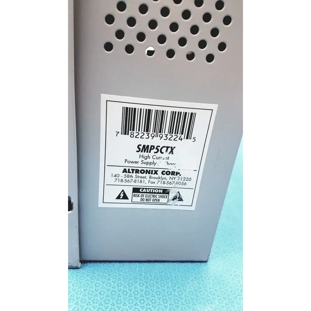 Gray metal altronix smp5ctx high current power supply with perforated ventilation and model number label smp5ctx