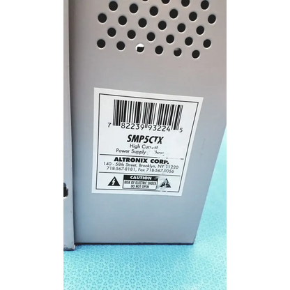 Gray metal altronix smp5ctx high current power supply with perforated ventilation and model number label smp5ctx