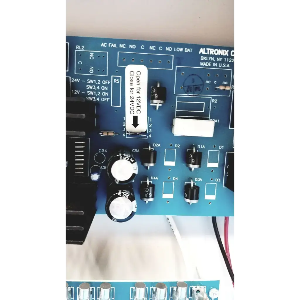 Blue altronix smp5ctx high current power supply circuit board with black and white electronic components visible