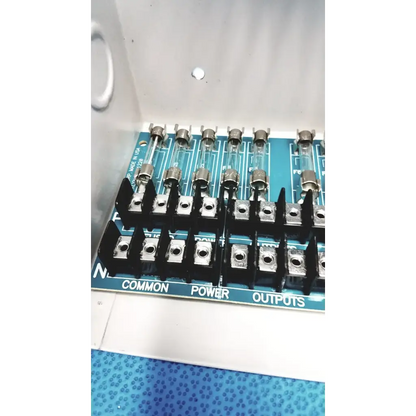 Blue circuit board with black terminal blocks and glass fuses in altronix smp5ctx high current power supply charger