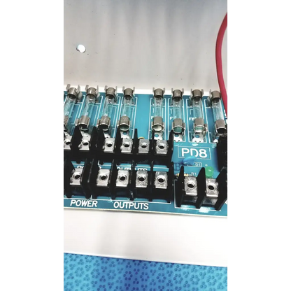 Blue pd8 power distribution board with black terminal blocks and glass fuses for altronix smp5ctx high current supply