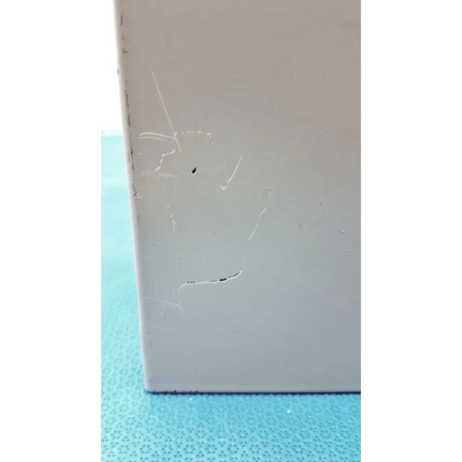 A light gray rectangular altronix smp5ctx high current power supply charger with minor scratches and a small dark spot