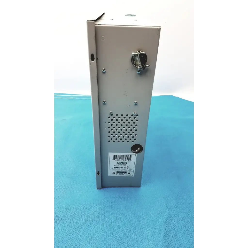 Gray metal altronix smp5ctx high current power supply with perforated panel and key-operated lock on the side