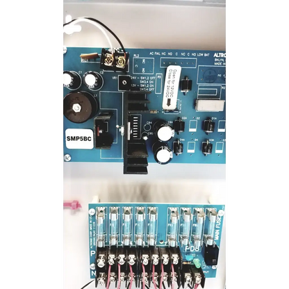 Blue circuit board with white labels and black components of altronix smp5ctx high current power supply charger