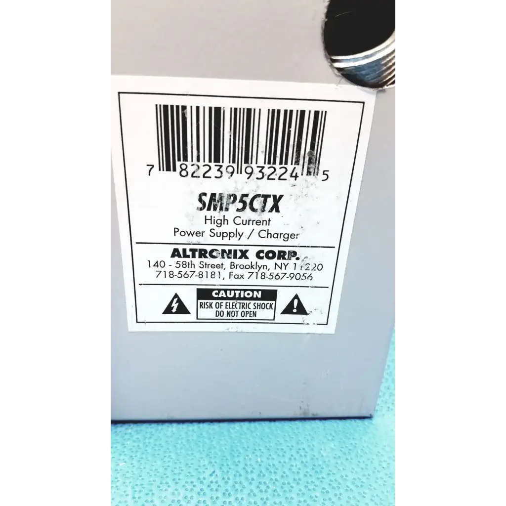 Gray plastic altronix smp5ctx high current power supply charger with white label and barcode for 12vdc 24vdc use