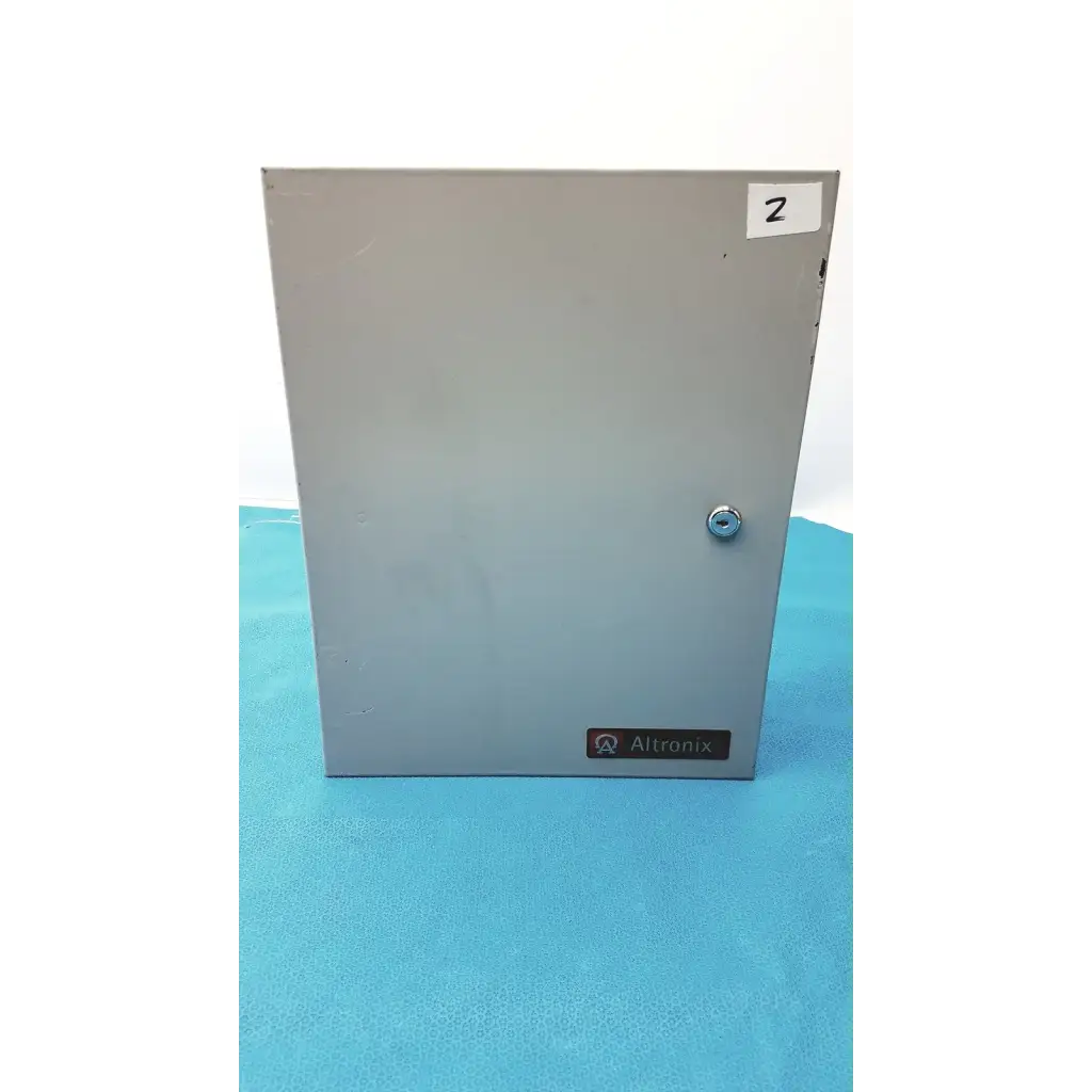 Gray metal electrical enclosure of altronix smp5ctx high current power supply charger with silver lock and altronix label
