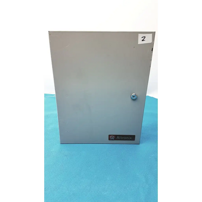 Gray metal electrical enclosure of altronix smp5ctx high current power supply charger with silver lock and altronix label