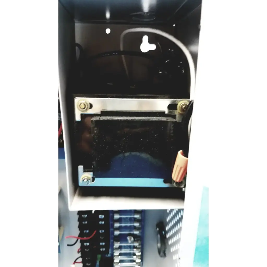 Black rectangular altronix smp5ctx high current power supply with metallic brackets and wiring inside white enclosure