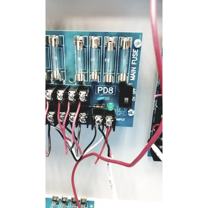 Blue Altronix SMP5CTX high current power supply circuit board with clear glass fuses and labeled terminals visible