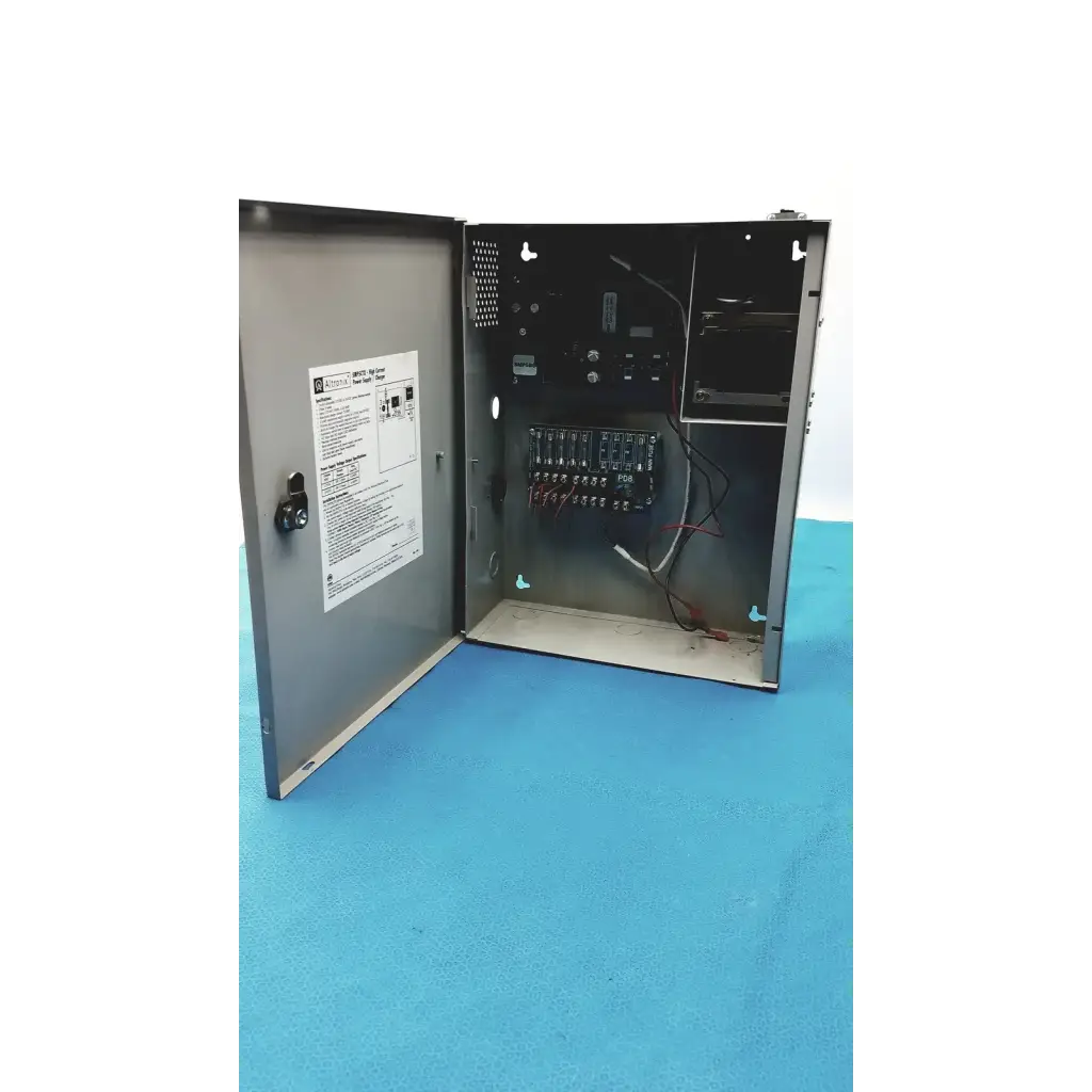 Gray metal electrical control panel with internal wiring and terminal blocks in altronix smp5ctx power supply charger