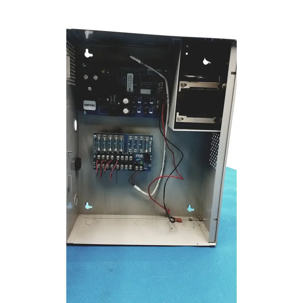 Black metal altronix smp5ctx power supply with visible internal circuit boards and wiring for 12vdc or 24vdc use