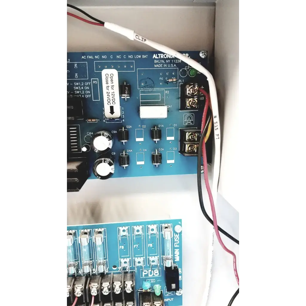 Blue altronix smp5ctx power supply panel with white labels and black components for 12vdc or 24vdc power charging