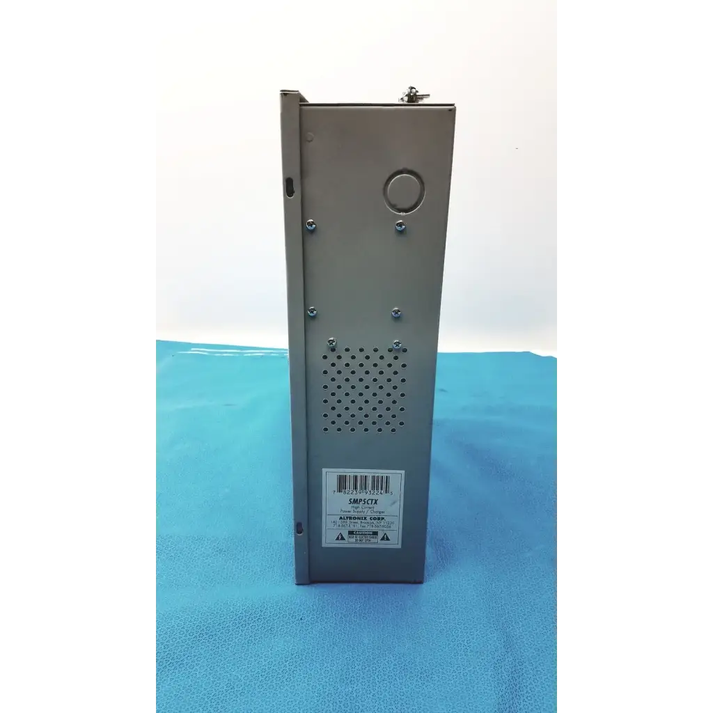 Gray metallic altronix smp5ctx power supply with perforated ventilation panel and labeled model number front view
