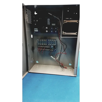 Metallic gray altronix smp5ctx power supply with blue circuit boards red and black wiring and white pdr label inside panel