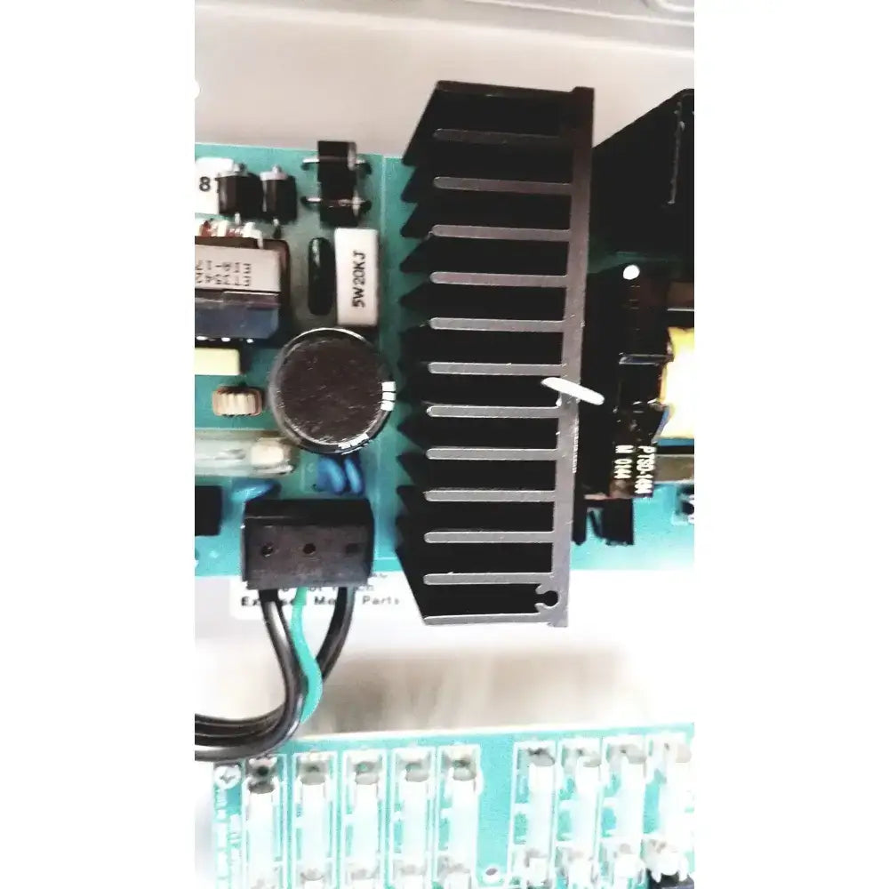 Black heat sink with vertical fins on teal circuit board of altronix smp7-ctx high current power supply charger