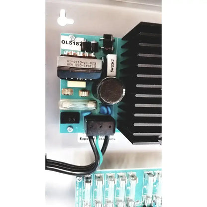 Teal printed circuit board with black components and heat sink in altronix smp7-ctx high current power supply