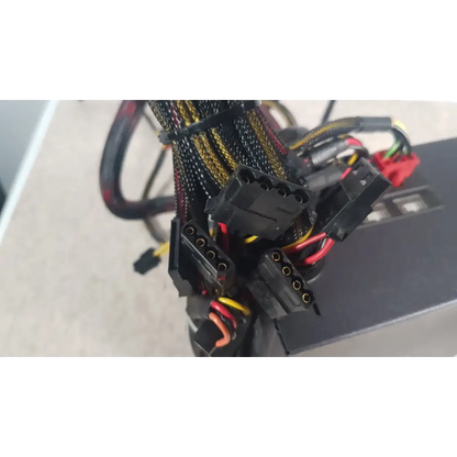 Black power supply cables with yellow and red wiring bundled by zip ties on the antec truepower 550w black unit