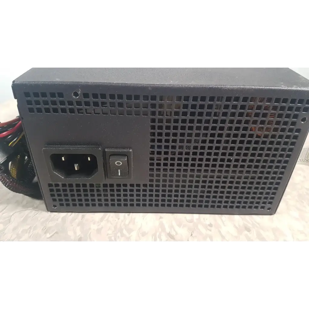 Black rectangular truepower 550w power supply with perforated metal casing ac input port and on/off switch backside view