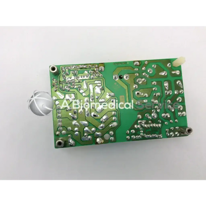 Green rectangular circuit board with silver soldered components and four mounting holes for artesyn open frame power supply