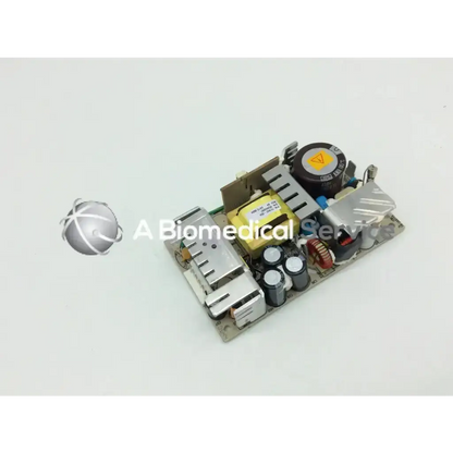 Silver and black artesyn nlp65-9910 ac-dc power supply board with capacitors resistors and connectors for electronic use
