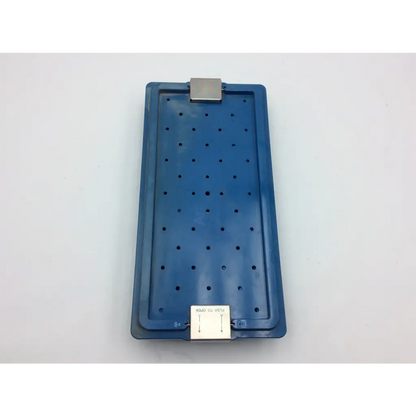 Blue plastic arthrex surgical orthopedic transfix ii acl tray with metallic clip and white label for acl reconstruction case
