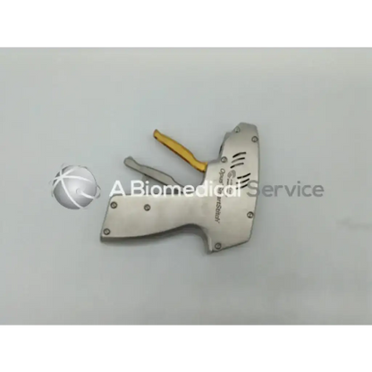 Silver metallic arthrocare opus medical smartstitch suturing device handle with yellow grip and engraved branding